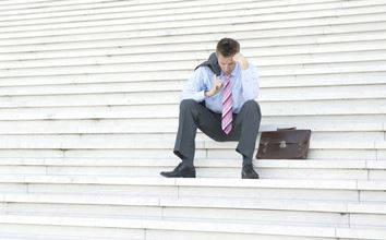 Unemployed man sitting on the steps
