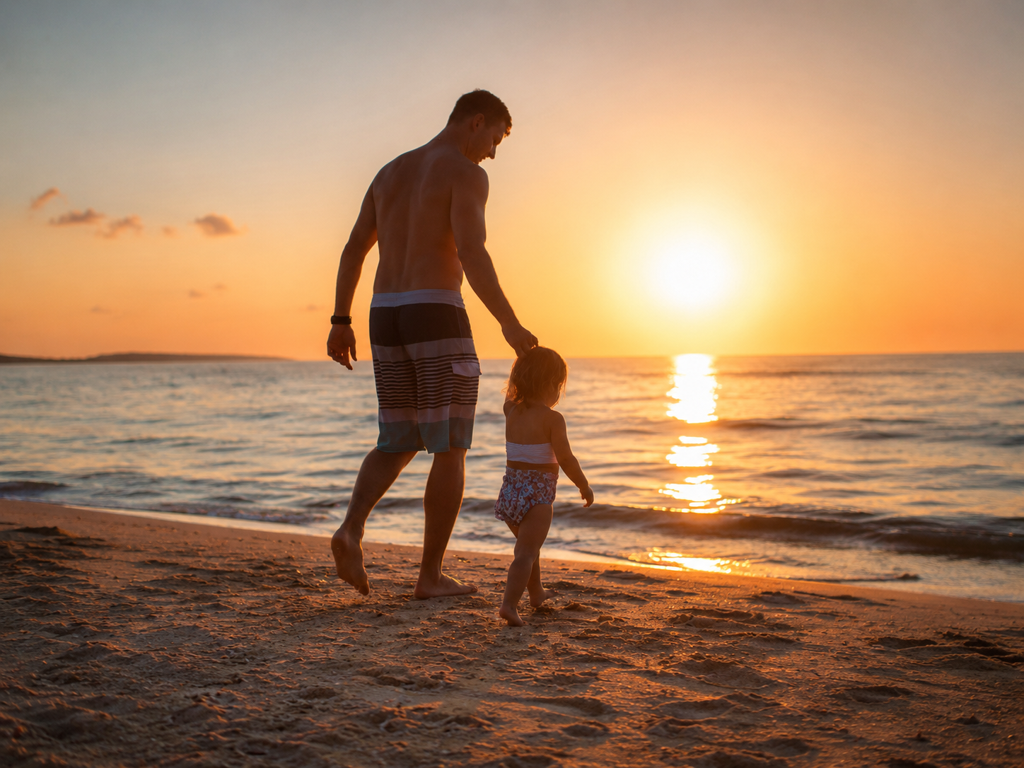 Father walking with his young child on a beach, representing life insurance protection for foreign families in Japan.